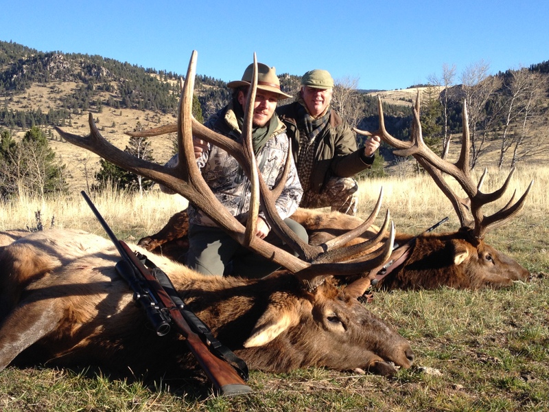 Two hunters with large elk